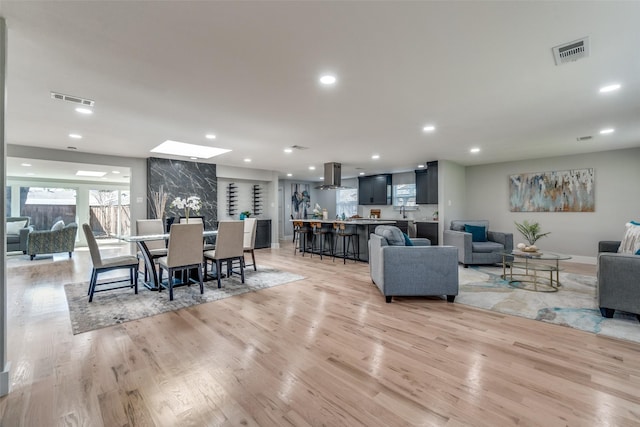 dining area with recessed lighting, visible vents, and light wood-style flooring