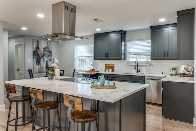 kitchen with electric cooktop, island exhaust hood, light stone counters, a sink, and dishwasher