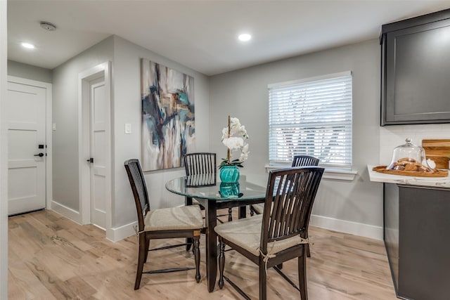 dining room with recessed lighting, light wood-type flooring, and baseboards