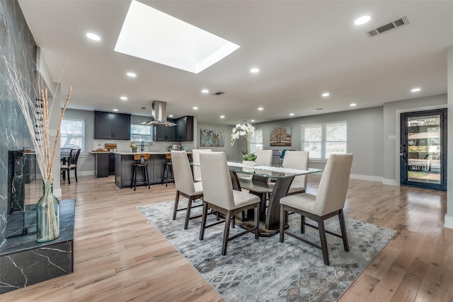 dining area with recessed lighting, visible vents, and light wood finished floors