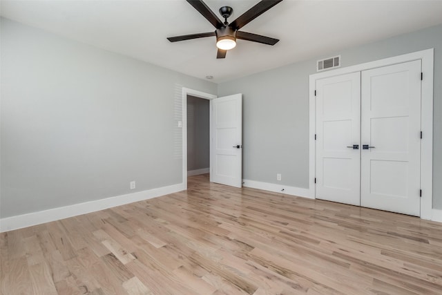 unfurnished bedroom featuring baseboards, visible vents, and light wood-type flooring