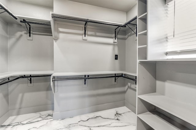 spacious closet with marble finish floor