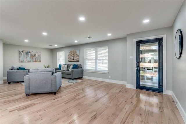 living room with recessed lighting, visible vents, and light wood-style flooring