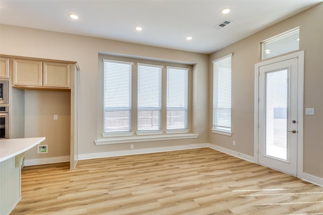 unfurnished dining area with light wood-style flooring, recessed lighting, visible vents, and baseboards