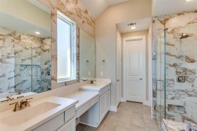 bathroom with vanity, visible vents, a stall shower, tile patterned flooring, and vaulted ceiling