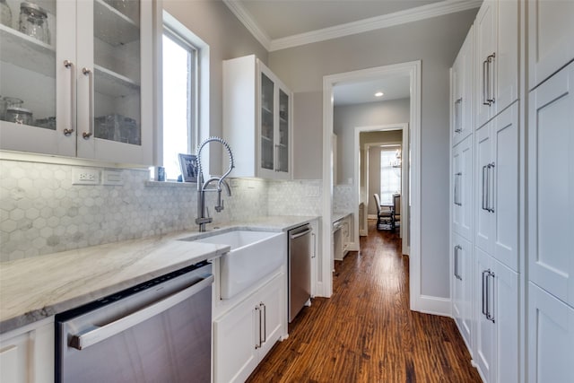 kitchen featuring crown molding, light stone countertops, stainless steel dishwasher, white cabinets, and a sink