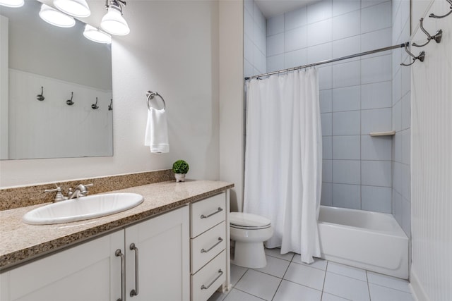 bathroom featuring tile patterned flooring, shower / tub combo, toilet, and vanity