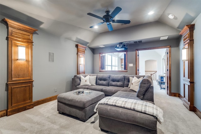 living area with light colored carpet, baseboards, and lofted ceiling