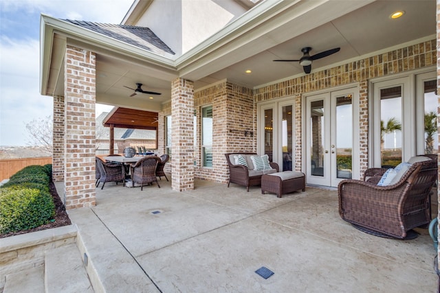 view of patio / terrace with a ceiling fan, outdoor dining space, french doors, and an outdoor hangout area