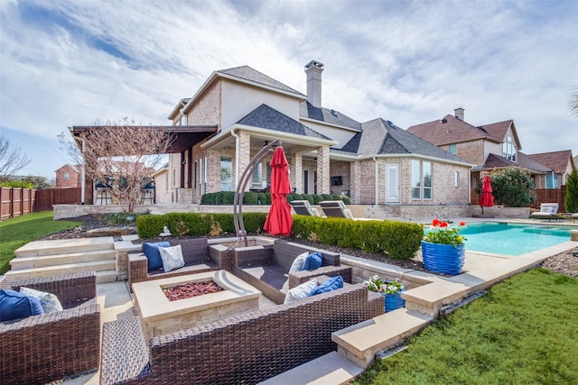 rear view of house featuring stucco siding, a patio, fence, an outdoor living space with a fire pit, and a fenced in pool