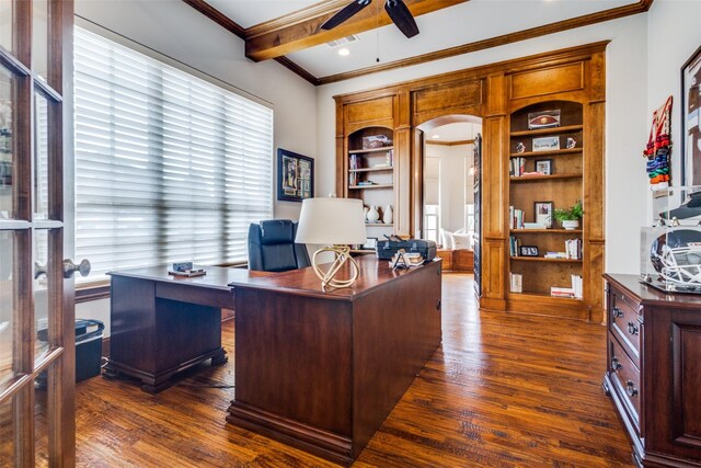 office with visible vents, dark wood finished floors, beamed ceiling, ornamental molding, and arched walkways