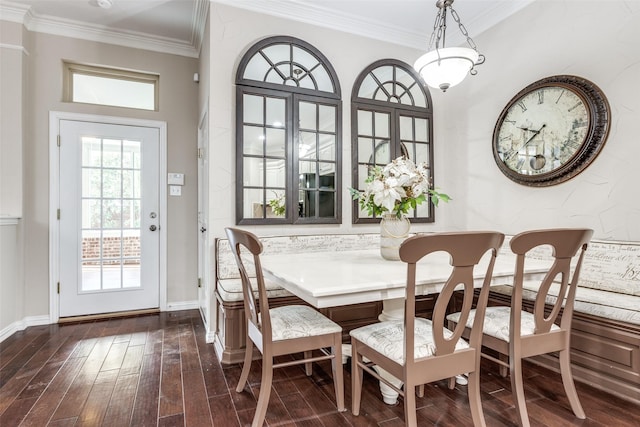 dining space featuring breakfast area, crown molding, baseboards, and dark wood-style flooring