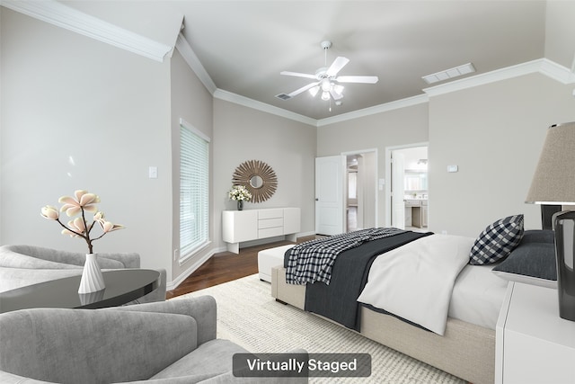 bedroom featuring visible vents, crown molding, baseboards, and wood finished floors