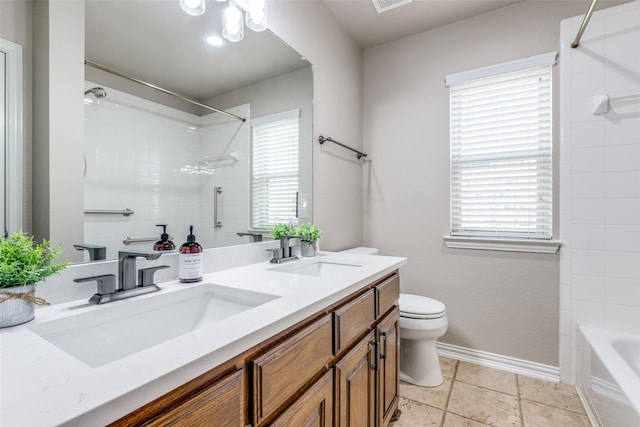 bathroom featuring plenty of natural light, toilet, and a sink