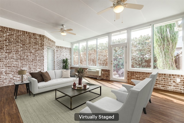 sunroom with a wall unit AC and a ceiling fan