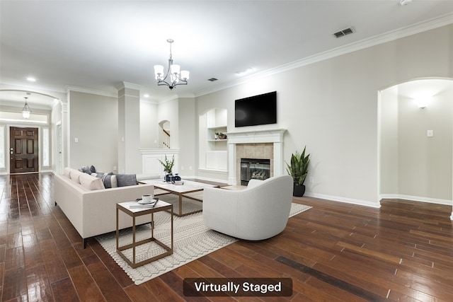 living area featuring dark wood-style floors, arched walkways, and a tile fireplace