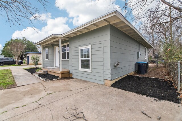 view of side of home with fence