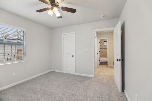 unfurnished bedroom with carpet, baseboards, and ceiling fan