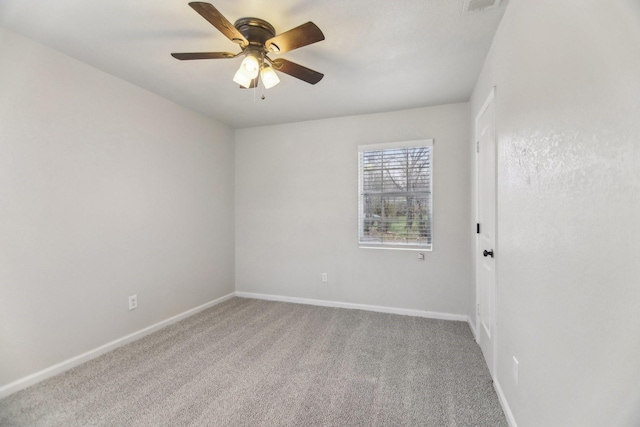 carpeted empty room with baseboards and ceiling fan