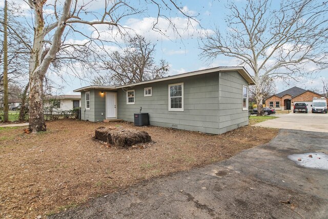 rear view of property featuring central air condition unit