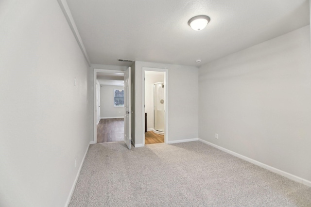 unfurnished room featuring visible vents, baseboards, and carpet floors