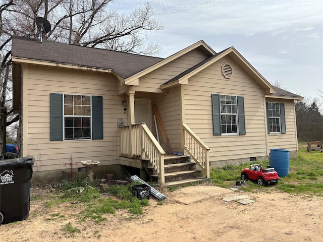 view of front of house with crawl space and a shingled roof