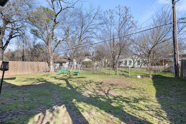 view of yard with a playground and fence