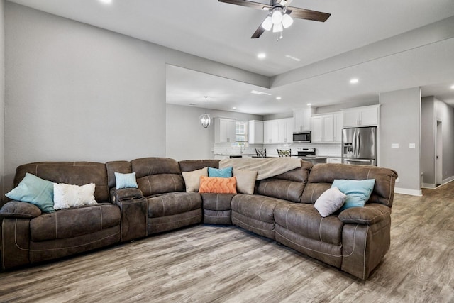 living area with recessed lighting, baseboards, light wood-style floors, and ceiling fan