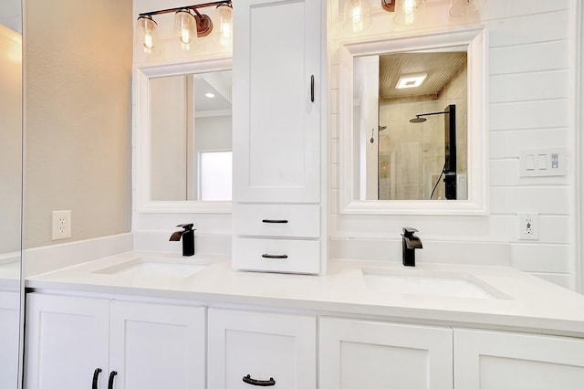 full bath with double vanity, a shower stall, and a sink