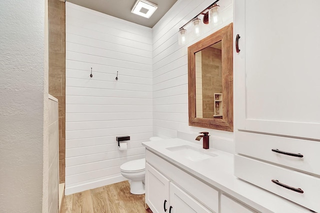 full bathroom featuring toilet, vanity, and wood finished floors