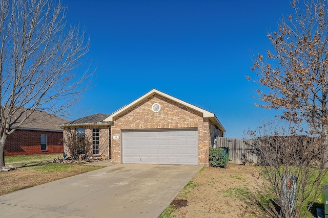 ranch-style house featuring brick siding, driveway, an attached garage, and fence