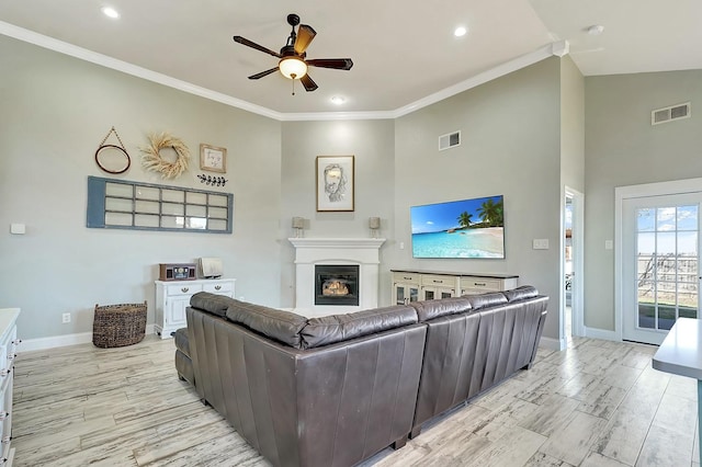 living area featuring visible vents, crown molding, light wood-type flooring, and ceiling fan