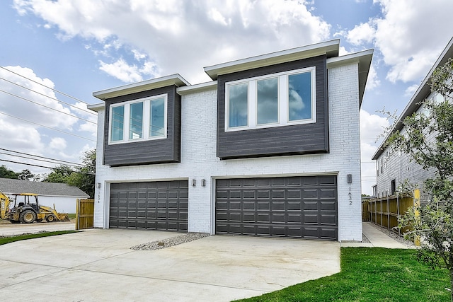 view of front of house featuring brick siding, driveway, a garage, and fence