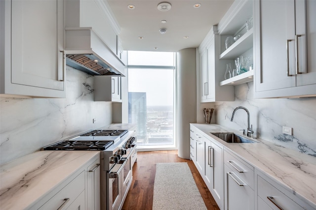 1918 Olive St Unit 3202, Dallas, TX 75201 - kitchen featuring double oven range, open shelves, custom exhaust hood, a sink, and white cabinets