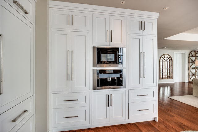 1918 Olive St Unit 3202, Dallas, TX 75201 - kitchen featuring wall oven, recessed lighting, white cabinets, black microwave, and dark wood-style flooring