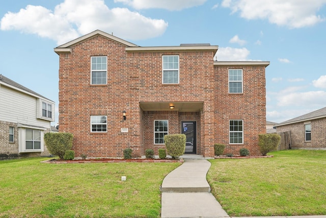 traditional-style home featuring a front lawn and brick siding