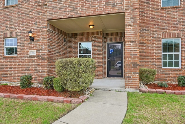 property entrance with brick siding