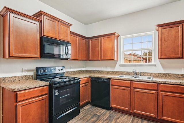 kitchen featuring dark wood finished floors, black appliances, and a sink