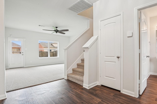 stairs featuring visible vents, baseboards, and wood finished floors