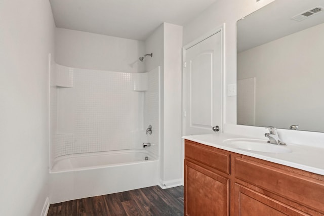 full bathroom featuring visible vents, shower / washtub combination, vanity, and wood finished floors