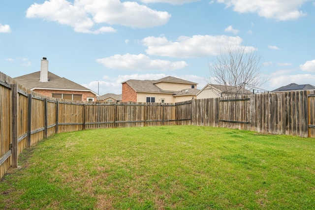 view of yard with a fenced backyard