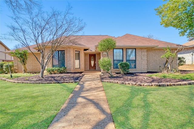 ranch-style house with brick siding and a front yard