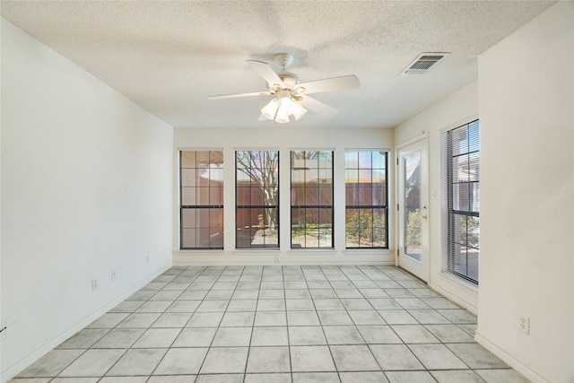 unfurnished sunroom with visible vents and ceiling fan