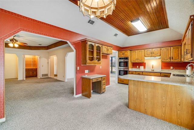 kitchen with visible vents, arched walkways, a sink, double oven, and light colored carpet