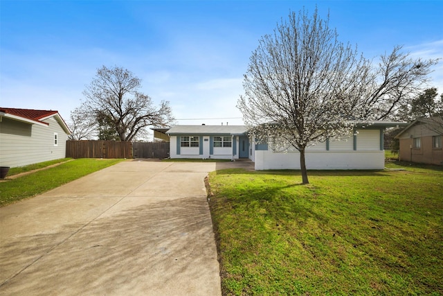 ranch-style home with concrete driveway, a front lawn, and fence