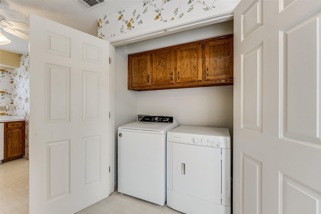 washroom with visible vents, cabinet space, independent washer and dryer, and wallpapered walls