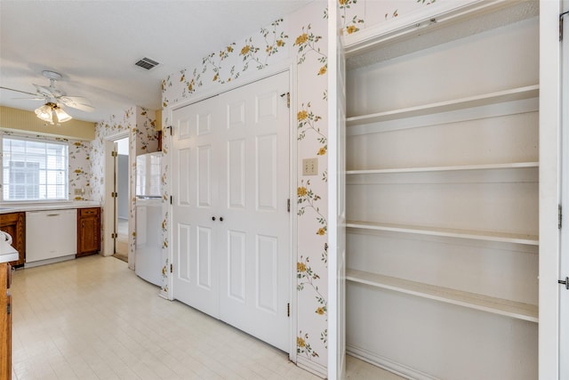 kitchen with visible vents, wallpapered walls, ceiling fan, and white dishwasher