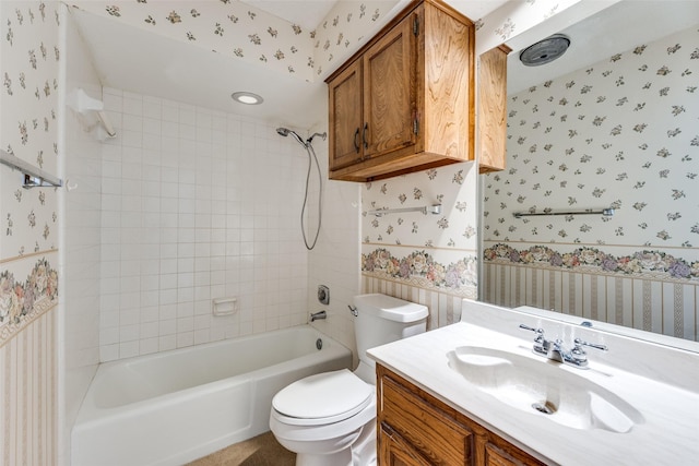 full bath with wallpapered walls,  shower combination, toilet, and vanity