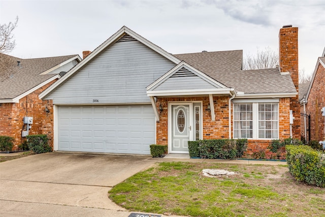 ranch-style home featuring roof with shingles, driveway, a chimney, a garage, and brick siding