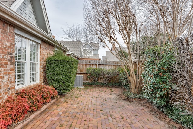 view of patio with central AC and fence